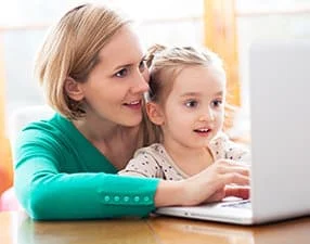 Woman and child using PC