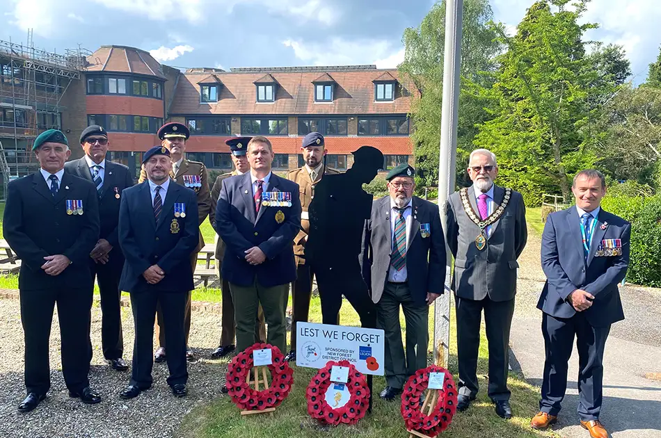 Group photo of staff and representatives from the military at New Forest District Council Grounds